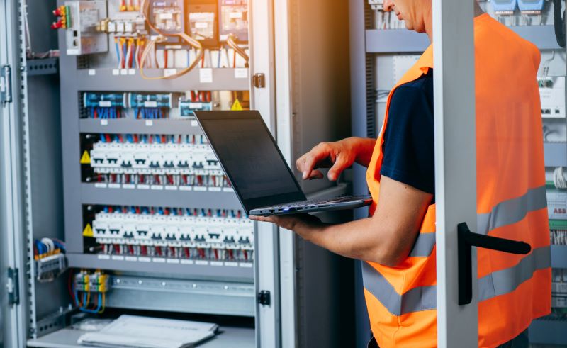 An engineer tests and adjusts equipment for a modern high-end automated building system.